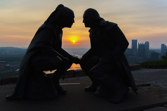 Sunrise between Point of View statue on Mt. Washington in Pittsburgh