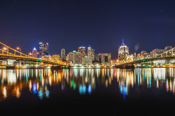 The Pittsburgh skyline shines before dawn on the North Shore