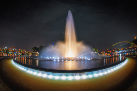 A fisheye view at night of the fountain at Point State Park in Pittsburgh