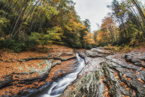 A fisheye view from below the natural rock slides at Ohiopyle State Park in the fall HDR
