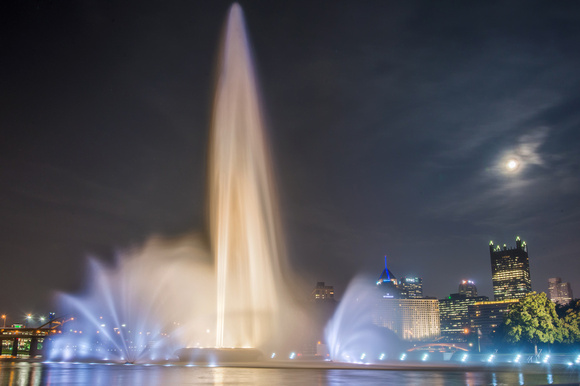 The moon shines bright over the fountain at Point State Park in Pittsburgh