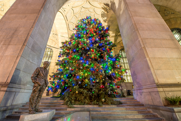 The Christmas tree and Richard Caliguiri statue at night in Pittsburgh