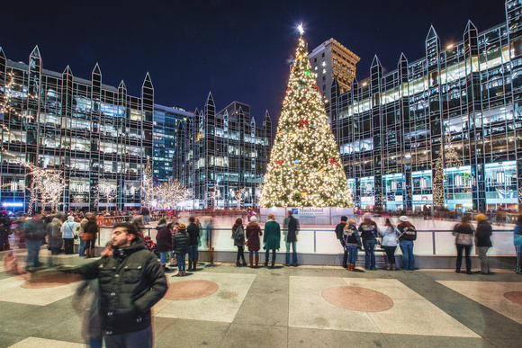People take a selfie by the tree at PPG Place in Pittsburgh during Light Up NIght