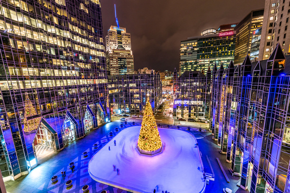 Skaters zip around the tree at PPG Place from the roof