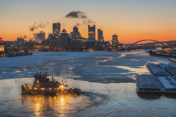 A barge is surrounded by steam on the icy Ohio River in Pittsburgh