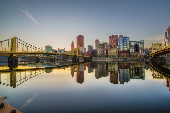 Wide angle view of the Pittsburgh skyline and reflections of the Andy Warhol and Roberto Clemente Bridges HDR