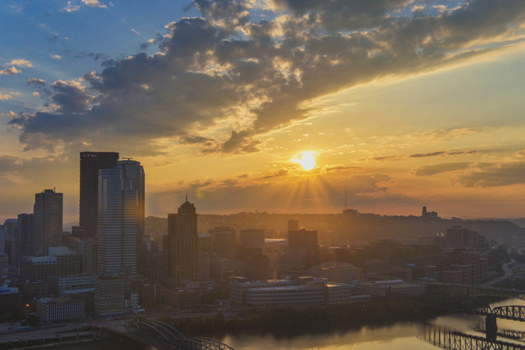 Sun flare through the clouds over Pittsburgh at dawn