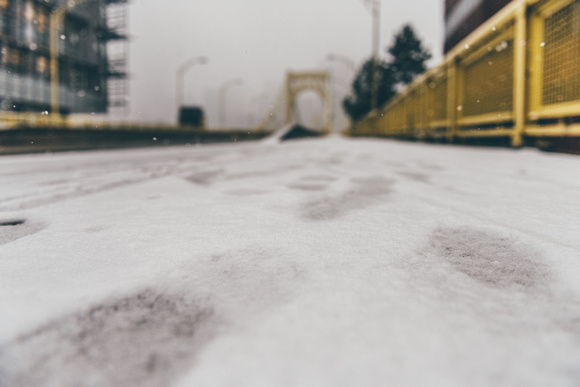 Footsteps in the snow on the Andy Warhol Bridge in Pittsburgh