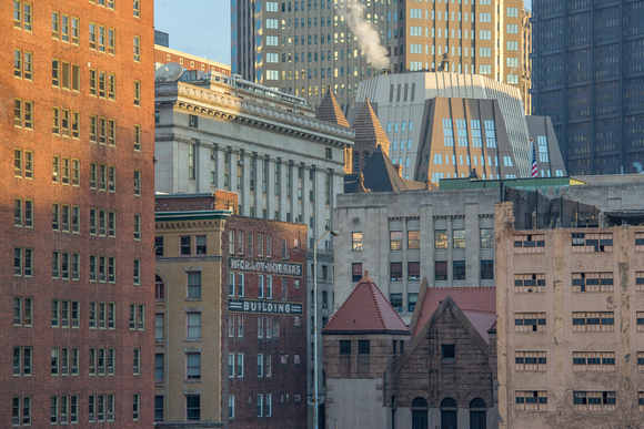 A cluster of buildings in downtown Pittsburgh at dawn