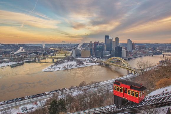 A car on the Duquesne Incline climbs Mt. Washington before a winter sunrise in Pittsburgh