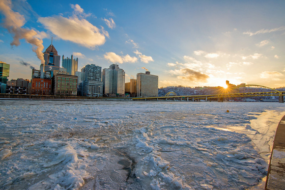 Sunflare over Mt. Washington by the iced over Allegheny River in Pittsburgh
