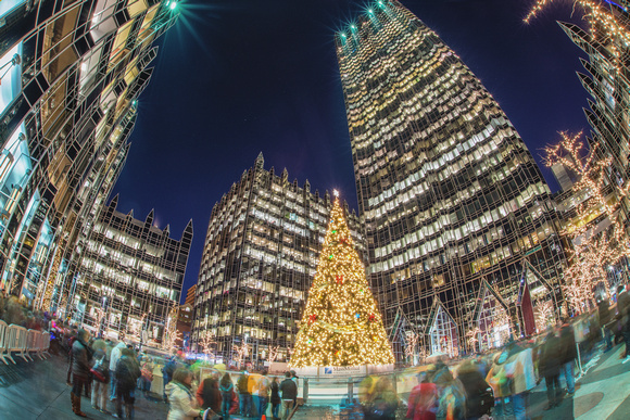 People shuffle around the Christmas tree at PPG Place in Pittsburgh