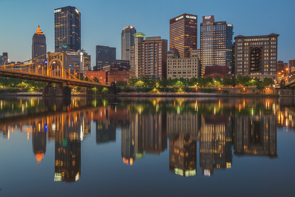 Reflections of Pittsburgh in the calm waters of the Allegheny River in the morning
