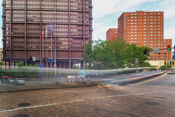 Cars rush through downtown Pittsburgh near the Steel Building