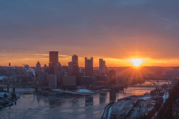 Sunflare through the clouds over Pittsburgh on a winter morning