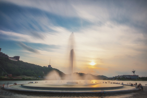 The sun sets behind the fountain at Point State Park in Pittsburgh