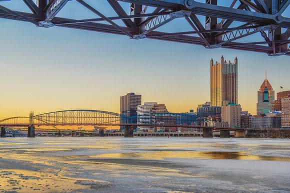 Sunset makes downtown Pittsburgh and the icy Monongahela River glow
