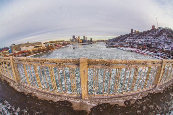 A fisheye view of the Pittsburgh skyline from the West End Bridge over the icy Ohio River