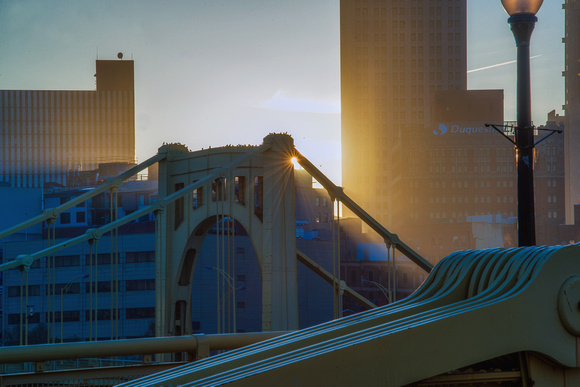 The sun glows as birds sit on the Andy Warhol Bridge in Pittsburgh HDR