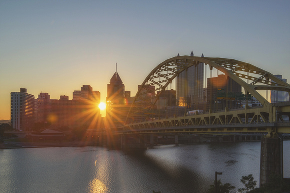 Sun through the Pittsburgh skyline at dawn