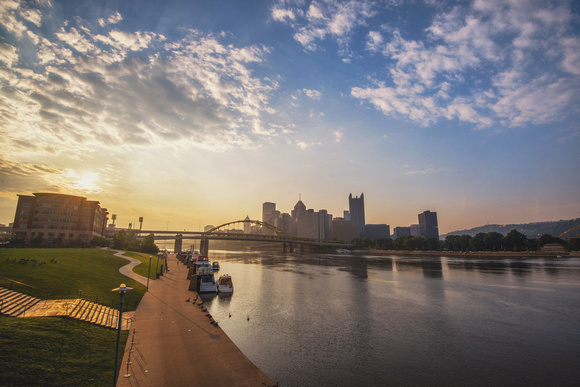 The sun glows on the horizon at dawn in Pittsburgh