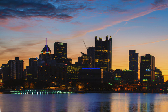 A colorful sky over a silhoeutted Pittsburgh skyline
