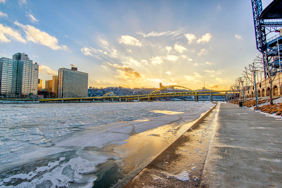 Sun rays over Mt. Washington as ice sits on the Allegheny River in Pittsburgh HDR