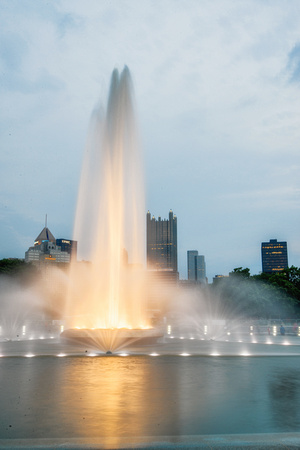 A golden glow of the fountain at Point State Park in Pittsburgh