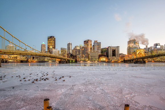 Wide angle view of Pittsburgh on the North Shore behind an ice covered Allegheny River
