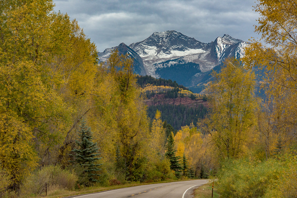 Ragged Peak in Colorado sits behind fall colors