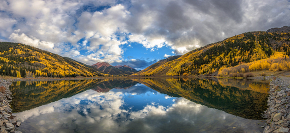 Panorama of reflections of Red Mountain in Crystal Lake on a fall afternoon in Colorado