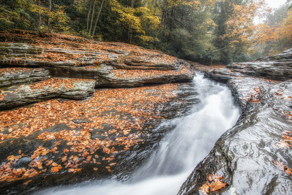 Early morning fog sits on top of the natural rock slides at Ohiopyle State Park HDR