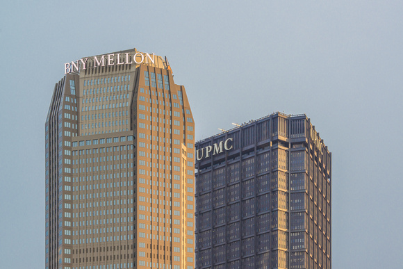 The Steel Building and BNY Mellon Building in downtown Pittsburgh are lit up at dawn