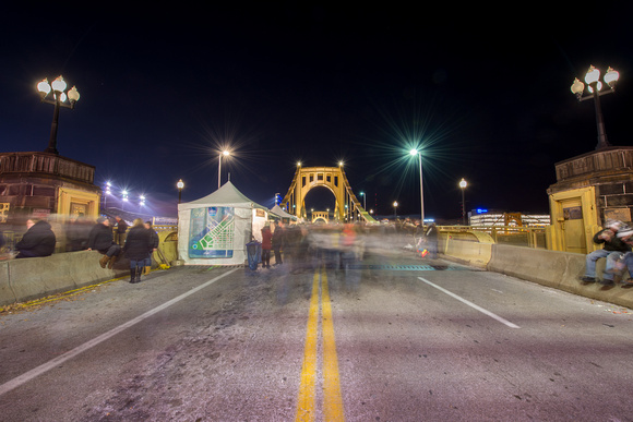 A rush of people on the Clemente Bridge in Pittsburgh for Light Up Night