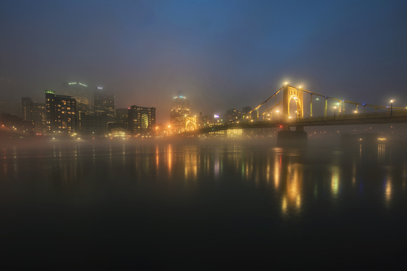 The Clemente Bridge in Pittsburgh glows in the fog