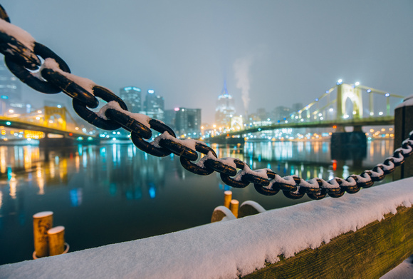 Snow falls on a chain along the North Shore of Pittsburgh