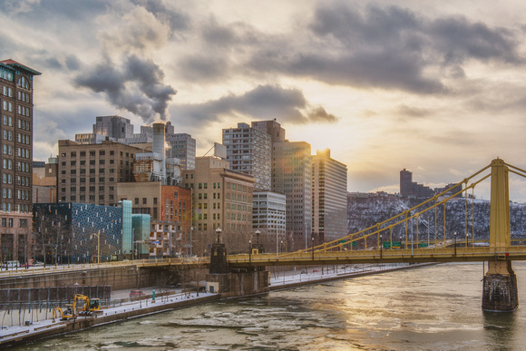 A sun flare over the Pittsburgh skyline as seen from the Andy Warhol Bridge
