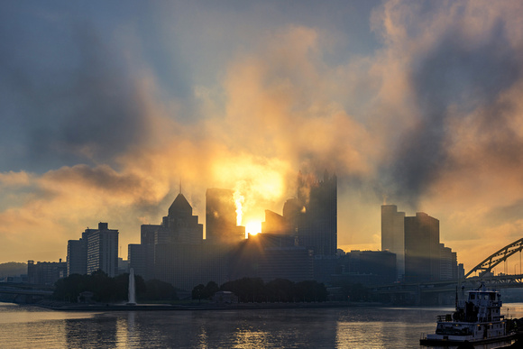 Sunlight bursts through the fog during a stunning Pittsburgh sunrise