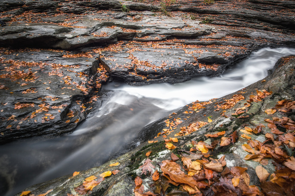 Water rushing down the natural rock slides at Ohiopyle State Park in the fall