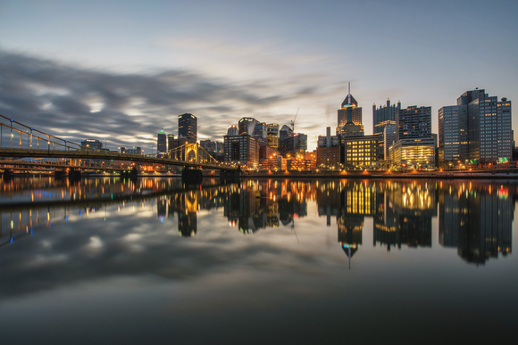 A long exposure of clouds rushing over the Pittsburgh skyline