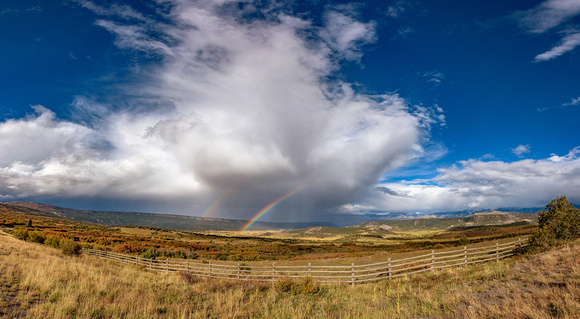 Panorama of a rainbow in Dallas Divide during fall in Colorado