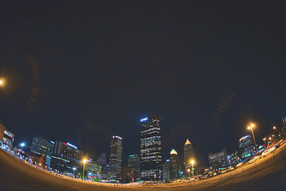 A fisheye view of the Pittsburgh skyline at night from uptown
