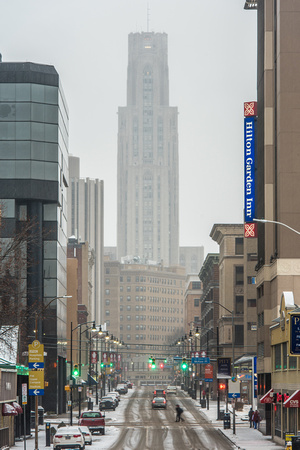 The Cathedral of Learning down Forbes Avenue in the snow
