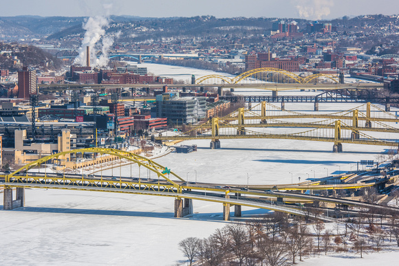 Bridges cross a snow and ice covered Allegheny River in Pittsburgh