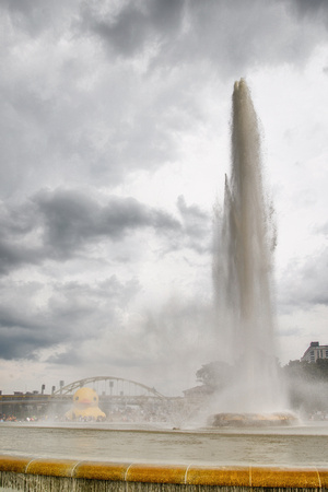 The fountain at Point State Park in Pittsburgh rises against a cloudy sky