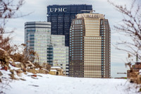 Pittsburgh rises above a snowy hillside