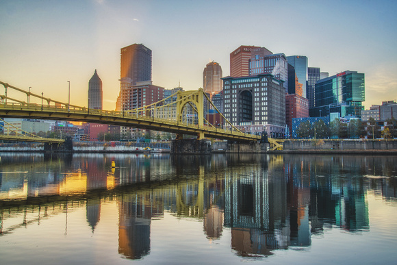 Crisp reflections of the Pittsburgh skyline and Roberto Clemente Bridge HDR