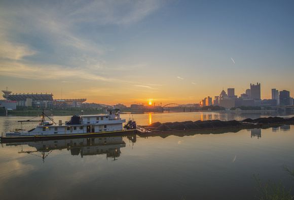Barge and the Pittsburgh skyline at dawn