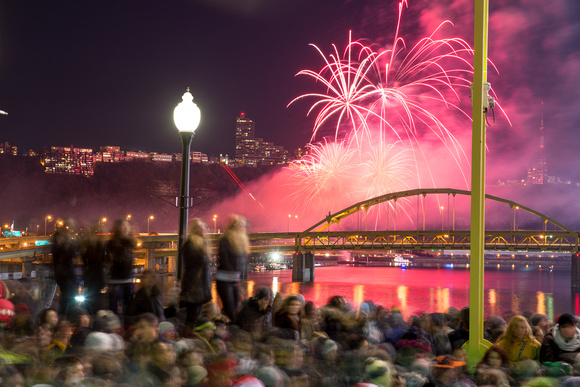 People on the Clemente Bridge watch the fireworks on Light Up Night in Pittsburgh