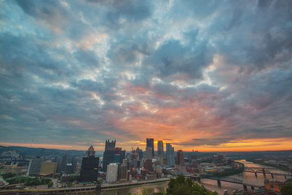 Sun coming through clouds at dawn over Pittsburgh